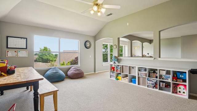 playroom with carpet floors, visible vents, lofted ceiling, baseboards, and ceiling fan