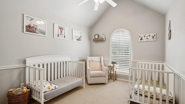 bedroom featuring carpet flooring, a ceiling fan, lofted ceiling, and a nursery area