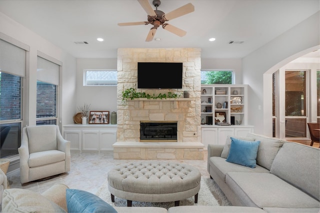 living room featuring visible vents, a healthy amount of sunlight, and a fireplace