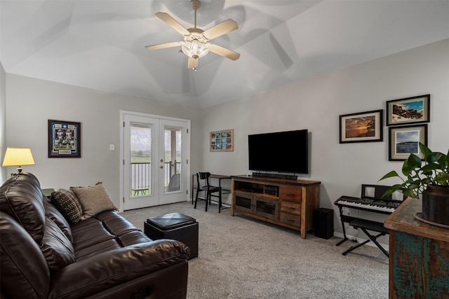 carpeted living area with french doors, ceiling fan, and vaulted ceiling