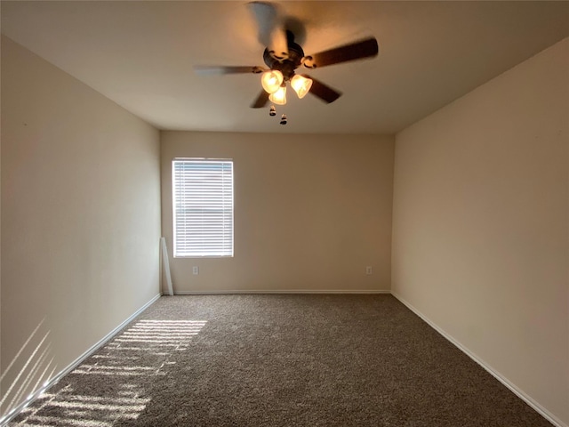 unfurnished room featuring carpet floors, baseboards, and a ceiling fan