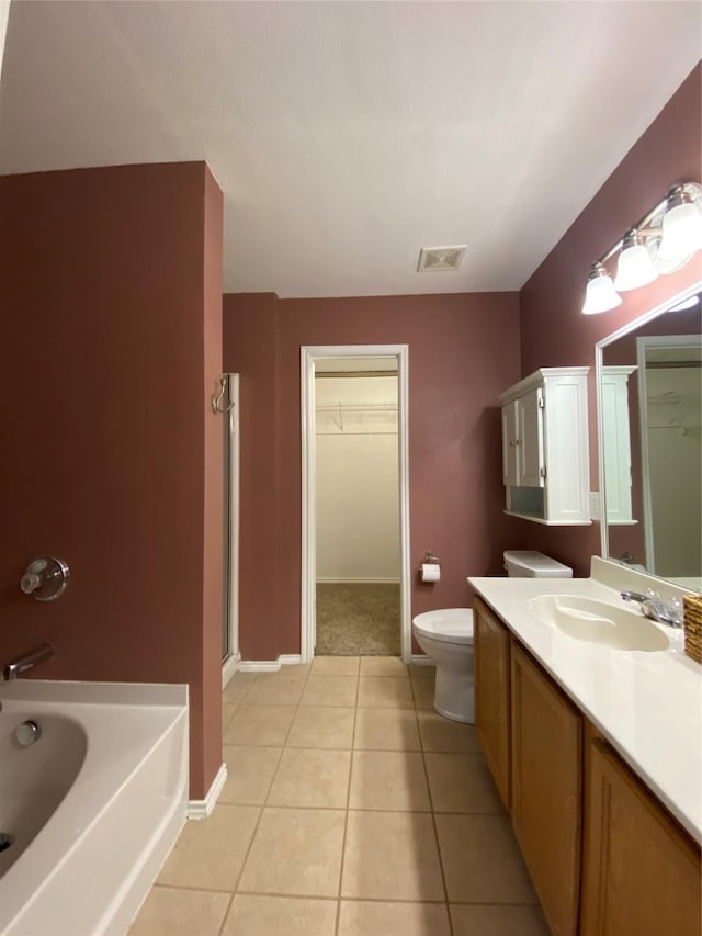 bathroom featuring visible vents, tile patterned flooring, a shower with shower door, vanity, and toilet