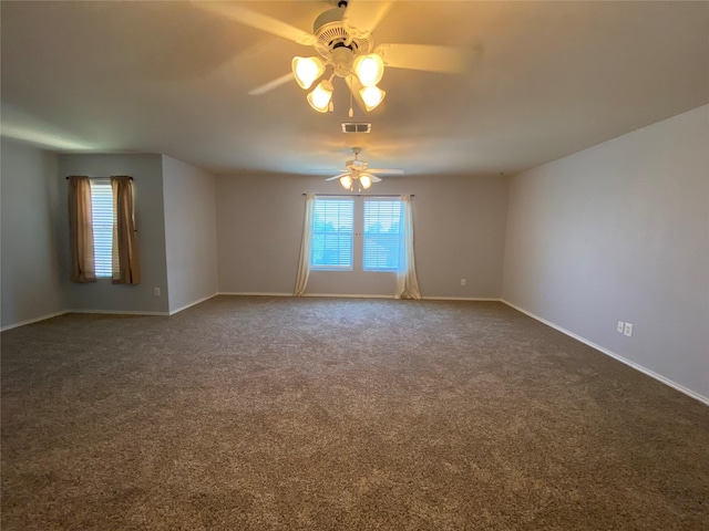 unfurnished room with visible vents, baseboards, ceiling fan, and dark colored carpet