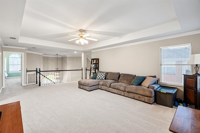 6017 Madera Ct, Plano, TX 75024 - living area featuring a raised ceiling, ceiling fan, carpet, crown molding, and a chandelier