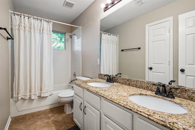 bathroom with toilet, visible vents, and a sink