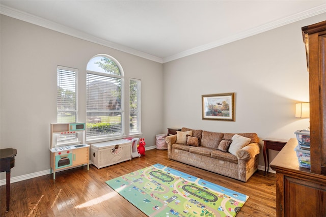 interior space featuring crown molding, baseboards, and wood finished floors