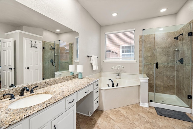 bathroom with vanity, recessed lighting, a bath, and a shower stall