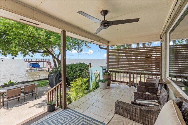 view of patio / terrace featuring a water view, ceiling fan, and outdoor dining space