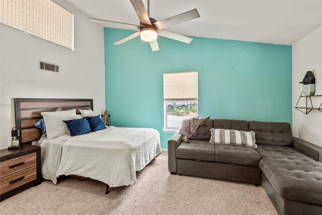 bedroom with high vaulted ceiling, a ceiling fan, carpet floors, and visible vents