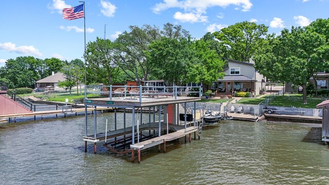 dock area featuring boat lift and a water view