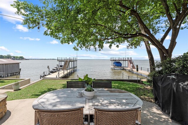 view of patio featuring a water view, boat lift, and a boat dock