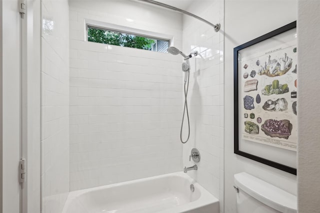 bathroom featuring shower / bathing tub combination and toilet
