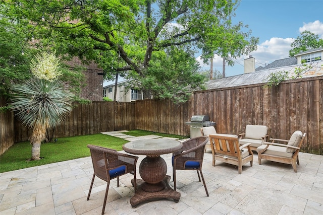 view of patio with outdoor dining area and a fenced backyard