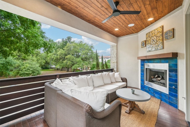 exterior space featuring ceiling fan and an outdoor living space with a fireplace