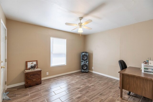 office space featuring baseboards, ceiling fan, and wood finish floors