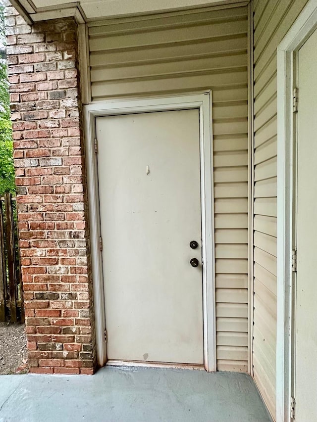 property entrance with brick siding
