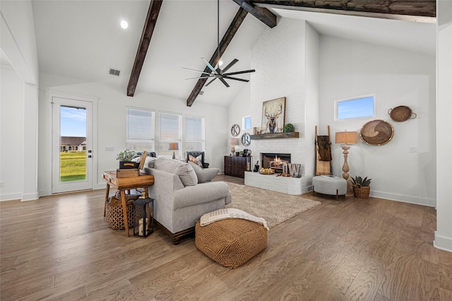 4771 Sasha Way, Caddo Mills, TX 75135 - living area featuring a fireplace, high vaulted ceiling, a ceiling fan, wood finished floors, and beamed ceiling