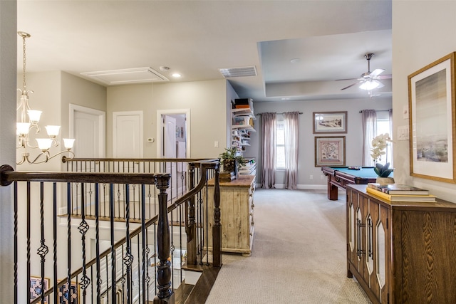 corridor with attic access, visible vents, baseboards, an upstairs landing, and carpet