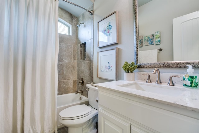 bathroom with vanity, shower / bath combo with shower curtain, and toilet