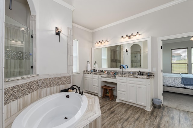 bathroom featuring connected bathroom, vanity, a shower stall, ornamental molding, and a garden tub