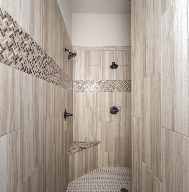 full bathroom with tiled shower