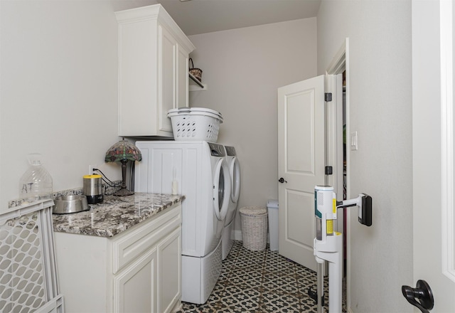 washroom featuring washing machine and clothes dryer, tile patterned floors, and cabinet space