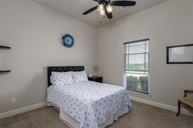 bedroom featuring a ceiling fan, baseboards, and light colored carpet