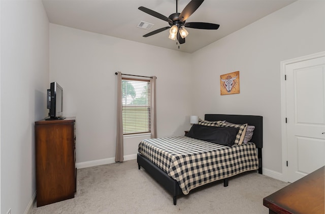 carpeted bedroom featuring visible vents, baseboards, and ceiling fan