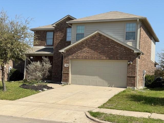 1206 Erika, Forney, TX 75126 - traditional home featuring brick siding, a garage, a front yard, and concrete driveway
