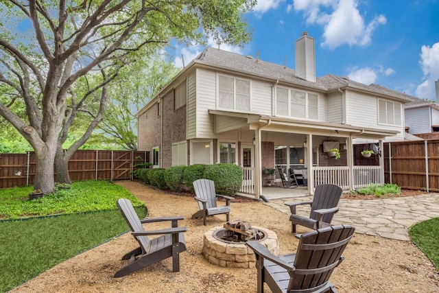 4400 Taylor Ln, Richardson, TX 75082 - rear view of property featuring a fire pit, a patio area, a chimney, and a fenced backyard
