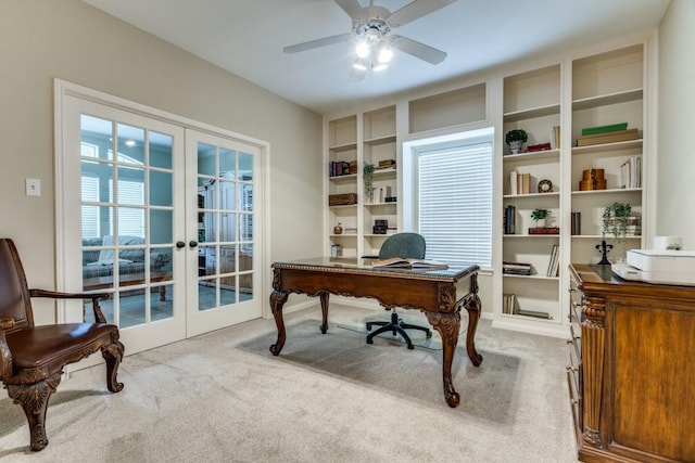 carpeted office featuring a ceiling fan, built in shelves, and french doors