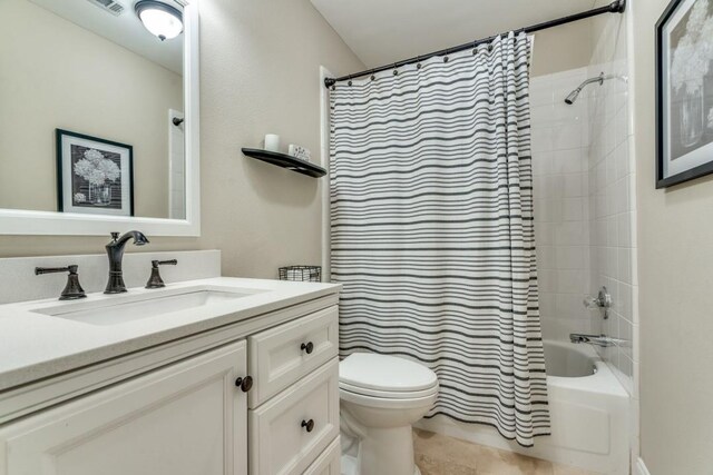 bathroom with visible vents, shower / tub combo, vanity, tile patterned floors, and toilet