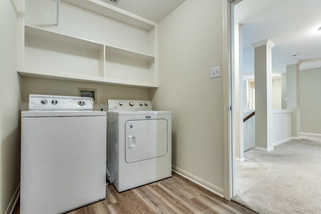 washroom with laundry area, light wood-style floors, independent washer and dryer, and baseboards
