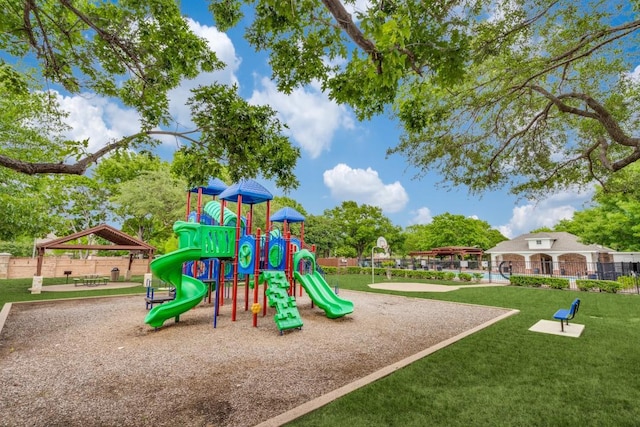 community playground featuring a lawn, fence, and a gazebo