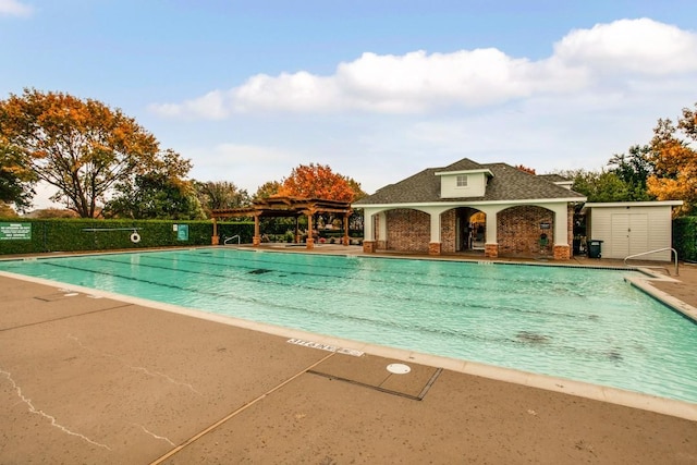 pool featuring a patio and a pergola
