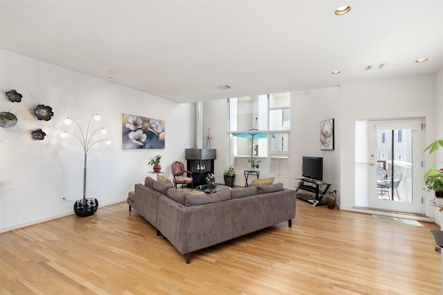 4030 Travis St Unit A, Dallas, TX 75204 - living room with light wood-type flooring, recessed lighting, and a wood stove