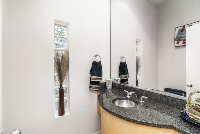 bathroom with vanity and baseboards