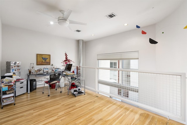 home office with visible vents, ceiling fan, and wood finished floors