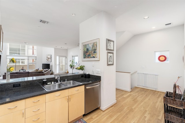 4030 Travis St Unit A, Dallas, TX 75204 - kitchen featuring stainless steel dishwasher, a sink, radiator heating unit, light brown cabinets, and light wood-type flooring