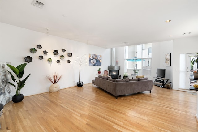 4030 Travis St Unit A, Dallas, TX 75204 - living room with light wood-style floors and a wood stove