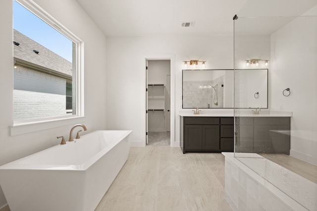 201 Kingfisher Ct, Aledo, TX 76008 - full bath with a freestanding tub, two vanities, a walk in closet, and baseboards