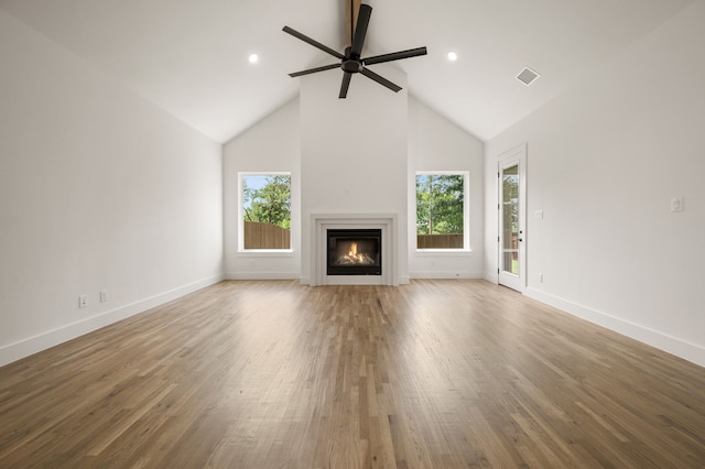201 Kingfisher Ct, Aledo, TX 76008 - unfurnished living room with a glass covered fireplace, ceiling fan, high vaulted ceiling, baseboards, and wood finished floors