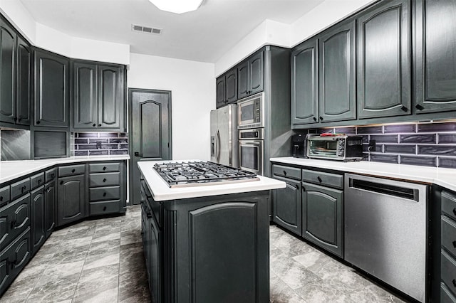 kitchen with visible vents, light countertops, decorative backsplash, and stainless steel appliances