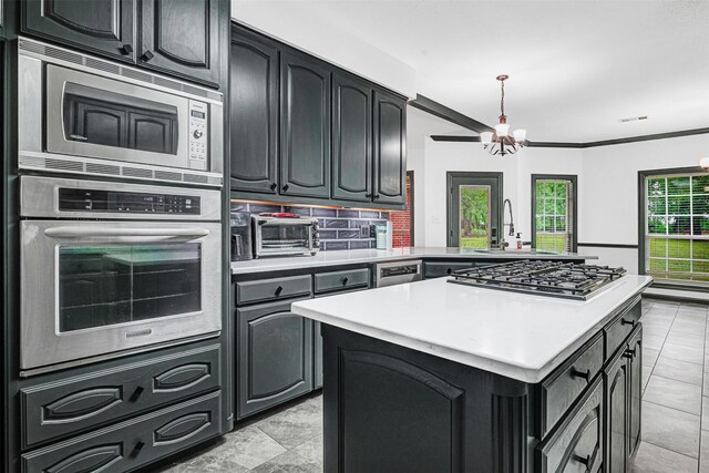 kitchen with light countertops, stainless steel appliances, a sink, and a toaster