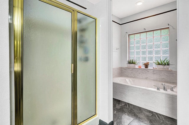 bathroom featuring a garden tub and a stall shower