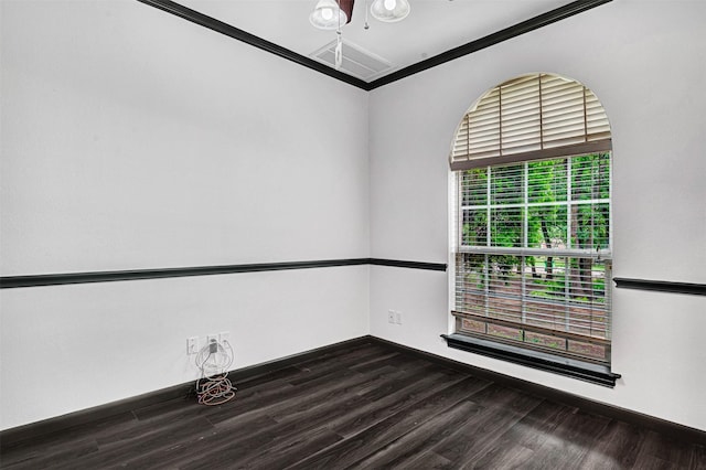 unfurnished room featuring baseboards, ornamental molding, and wood finished floors