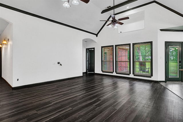 unfurnished living room with a ceiling fan, visible vents, arched walkways, wood finished floors, and baseboards