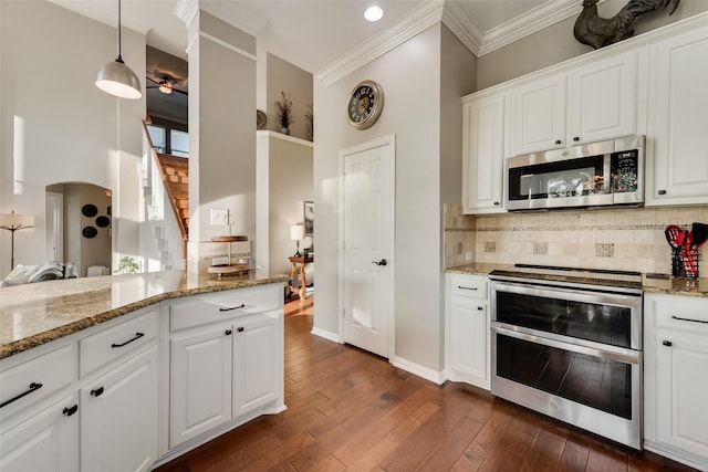 kitchen featuring decorative backsplash, dark wood-style flooring, light stone counters, stainless steel appliances, and white cabinetry
