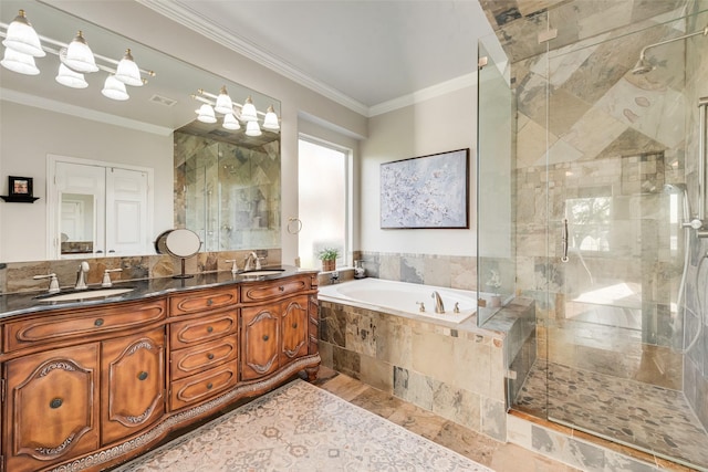 full bathroom with a sink, a bath, ornamental molding, and a shower stall