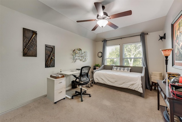 bedroom with light colored carpet, a ceiling fan, and baseboards